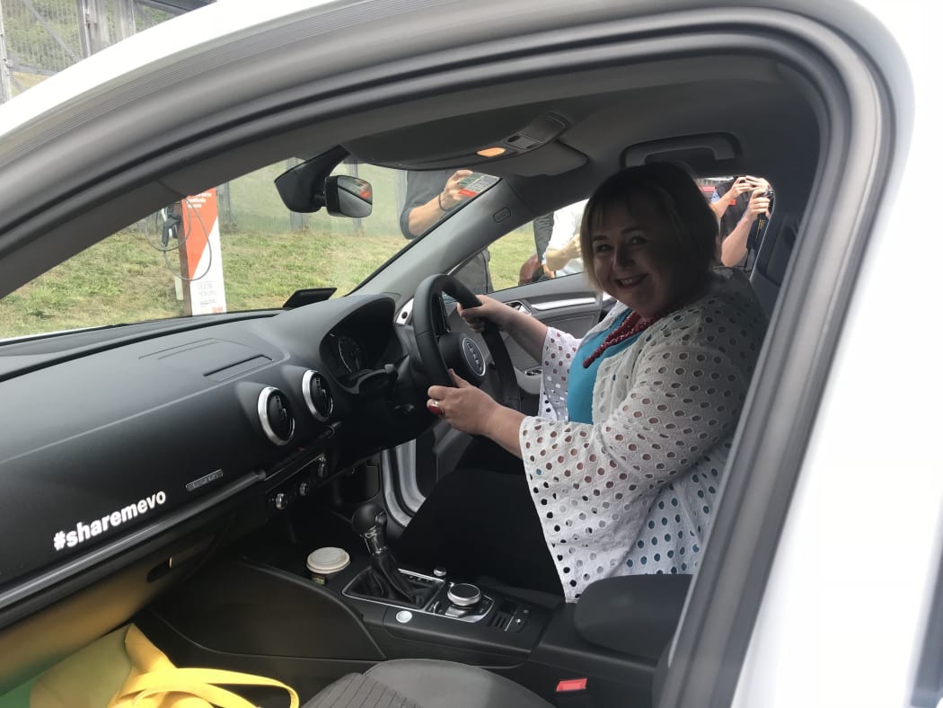 Megan Woods in a hybrid electric car.