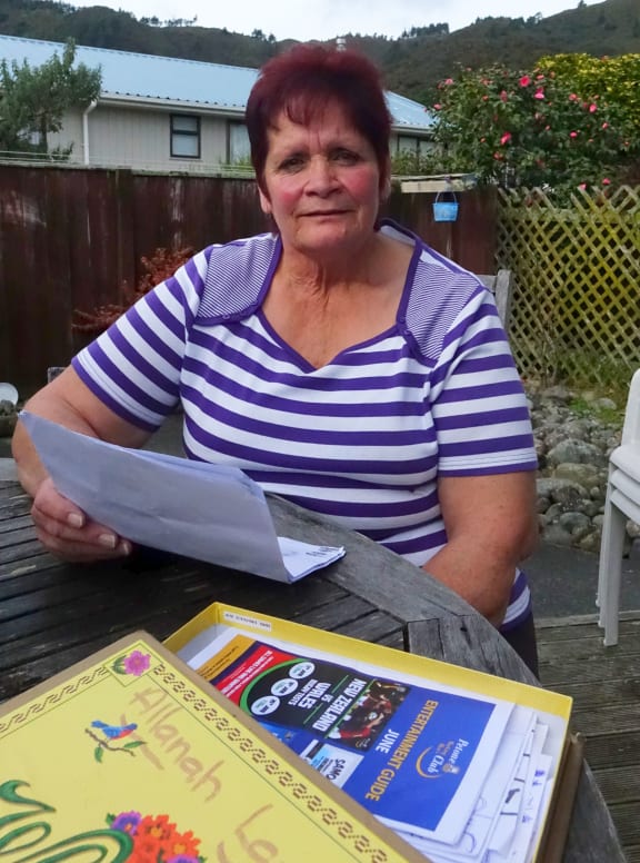 Former cleaner Allanah Lawer wants her former employers to pay out her redundancy in this pictures she holds a copy of a cleaning schedule for a school