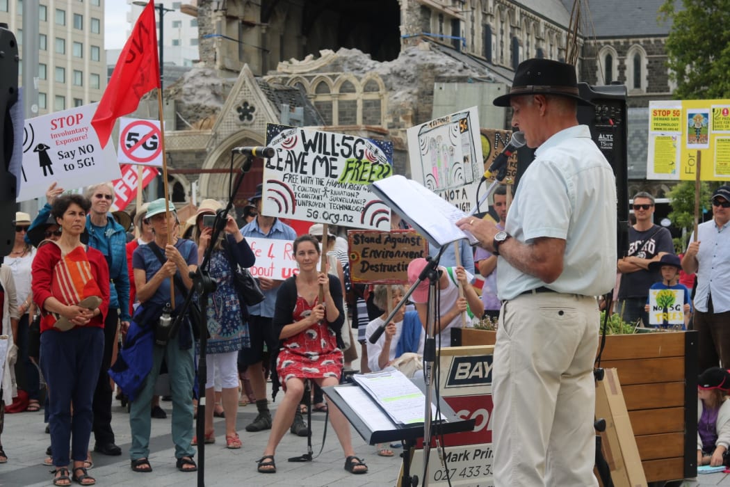About 200 anti-5G protesters have swarmed central Christchurch with placards, hazmat suits and songs about radiation.
