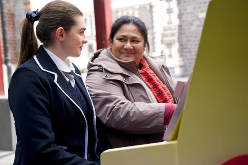 Sophie (Antonia Robertson) exchanges a look with her choir teacher Mareta (Anapela Polataivao) in the 2025 film Tinā.