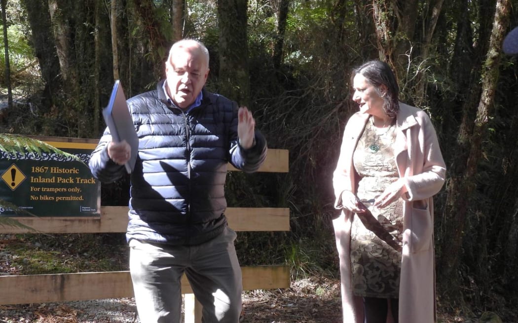 Former Conservation Minister Poto Williams looks on as DoC Western South Island director Mark Davies in October 2022 talks about the significance of a land acquisition for the department on the fringe of the Paparoa National Park.