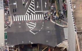 A giant sinkhole has swallowed a five-lane street in the centre of Fukuoka, Japan.
