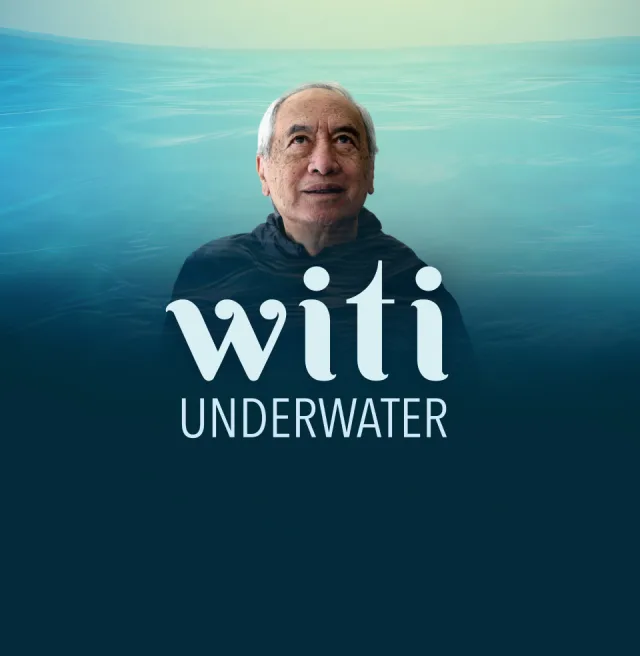 Witi Ihimaera glances upward in front of a water graphic. White text in front of him reads: "Witi Underwater."