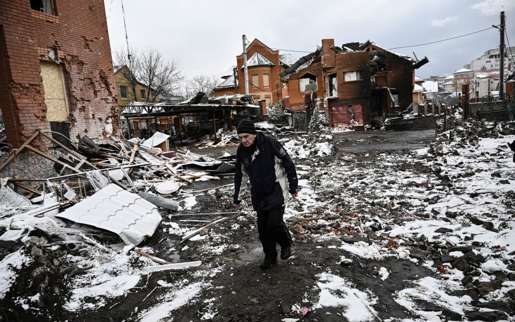 A man walks between houses destroyed during air strikes on the central Ukranian city of Bila Tserkva on 8 March, 2022.