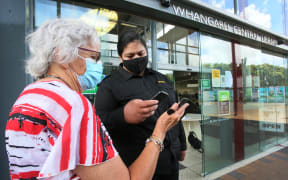 Northern Districts security guard Durhy Turner scans Margaret Johnson into WDC's Whangārei central library.