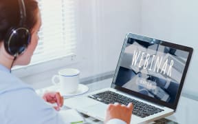 Woman watching webinar online on computer, business education concept, coaching.