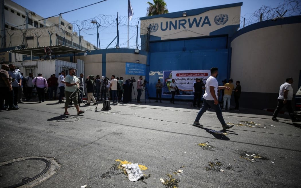 Palestinian protesters throw eggs at the entrance of the Gaza City headquarters of the United Nations Relief and Works Agency for Palestine Refugees (UNRWA) on August 7, 2023, during a demonstration demanding that their homes which were destroyed in the 2014 conflict with Israel be rebuilt.  (Photo by Majdi Fathi/NurPhoto) (Photo by MAJDI FATHI / NurPhoto / NurPhoto via AFP)