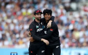 Rachin Ravindra of New Zealand is hugged by teammate Devon Conway