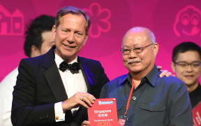 Michelin Guides international director Michael Ellis presents the award to Tang Chay Seng of Hill Street Tai Hwa Pork Noodle in Singapore on Thursday 21 July 2016.