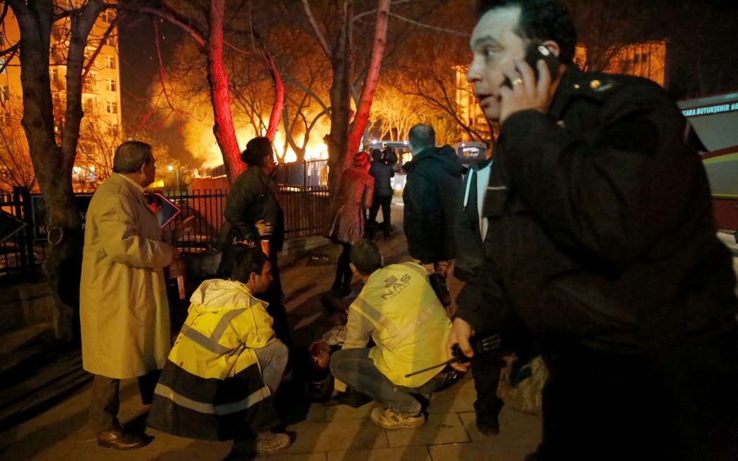 Emergency workers help an injured person near the site of the explosion.