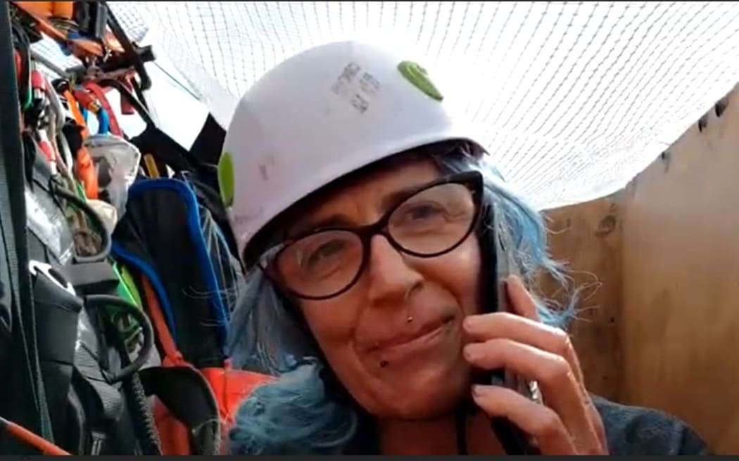 Rach Andrews on her cellphone in the aerial coal bucket.