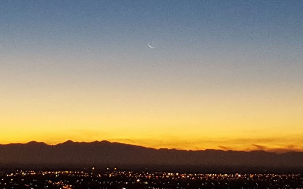 The waning crescent moon rising over Christchurch signals the beginning of Ramadan.