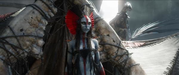 Varang is an alien-looking grey-skinned humanoid creature with a red and black headress.