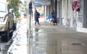 Fijians shelter from heavy rain in Nadi.