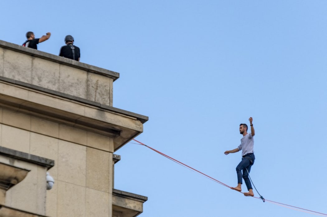 France, Paris, 2021-09-18, Tightrope walker Nathan Paulin walks on a cable between the Eiffel Tower and the Trocadero,