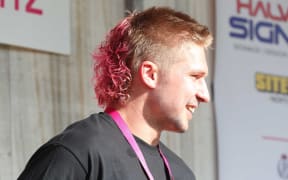All Black Jack Goodhue got to keep his mullet but made over with pink dye and a perm.