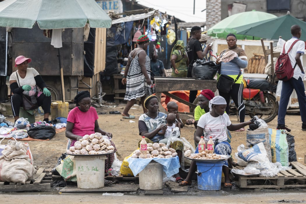 Street vendors sell nuts in a street in Douala, Cameroon, on 10 January, 2022.