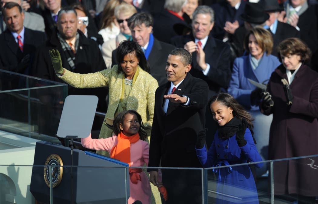 US President Barack Obama waves with his family after being sworn in as 44th US president January 20, 2009 in Washington, DC.