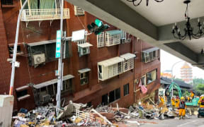 This frame grab from AFPTV video taken on April 3, 2024 shows rescue workers searching for survivors at the damaged Uranus Building in Hualien, after a major earthquake hit Taiwan's east. A major 7.4-magnitude earthquake hit Taiwan's east on the morning of April 3, prompting tsunami warnings for the self-ruled island as well as parts of southern Japan and the Philippines. (Photo by AFPTV / AFP) / “The erroneous mention appearing in the Byline of this photo has been modified in AFP systems in the following manner: [STR] instead of [Mahmoud Rizk]. Please immediately remove the erroneous mention from all your online services and delete it from your servers. If you have been authorized by AFP to distribute it to third parties, please ensure that the same actions are carried out by them. Failure to promptly comply with these instructions will entail liability on your part for any continued or post notification usage. Therefore we thank you very much for all your attention and prompt action. We are sorry for...