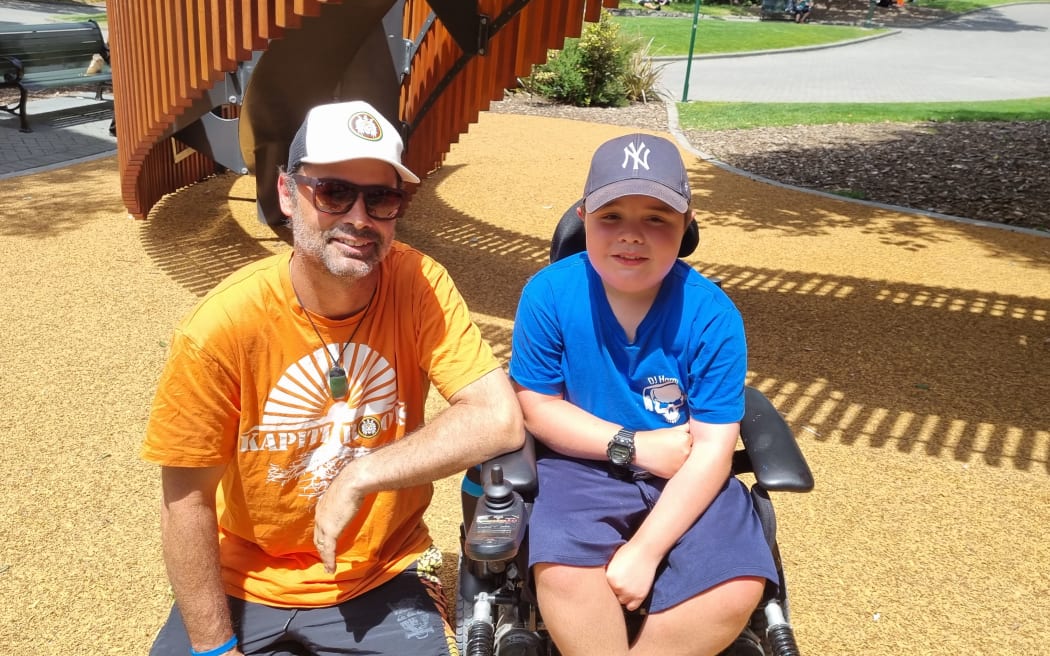 Harper, 10, who has muscular dystophy, with his father Dion.