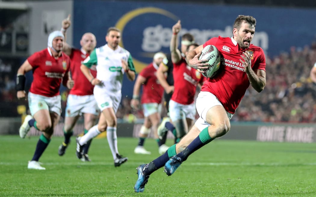 Lions' Jared Payne makes a break with the ball, scoring the team's fourth try of the match.
