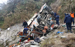 Rescuers work at the site of a bus accident by the Trishuli River in Dhading, Nepal, February 23, 2026. Nineteen people were killed, and 25 others were injured when a passenger bus en route to Kathmandu from Pokhara plunged into the Trishuli River in central Nepal's Dhading district early Monday, according to local administration.