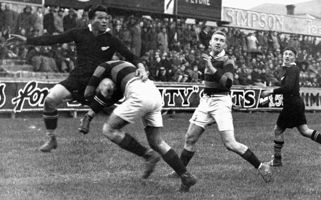 Legendary fullback George Nepia is tackled during a New Zealand Maori match against Wellington at Athletic Park,1935.