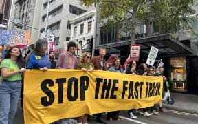 Protestors opposing the government's Fast Track Bill march down Auckland's Queen St on 8 June 2024.