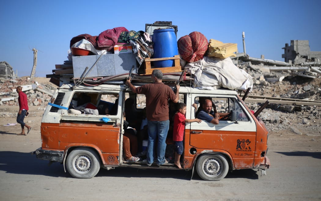 Displaced Palestinians move with their belongings southwards on a road in the Nuseirat refugee camp area in the central Gaza Strip following renewed Israeli evacuation orders for Gaza City on September 16, 2025. Israel launched its long-anticipated ground assault on Gaza City at dawn on September 16, a day after winning backing from its top ally the United States despite mounting international alarm. (Photo by Eyad BABA / AFP)