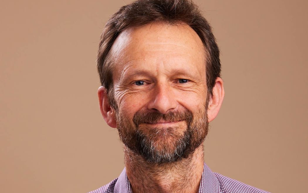 A headshot portrait of climate change commissioner and climate scientist Dr Andy Reisinger