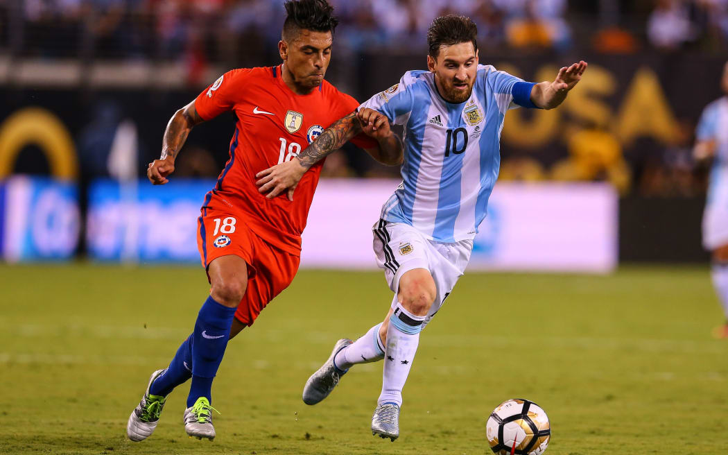 Argentina midfielder Lionel Messi (10) battles Chile defender Gonzalo Jara (18) during the second half of the Copa America Centenario Final between Argentina and Chile