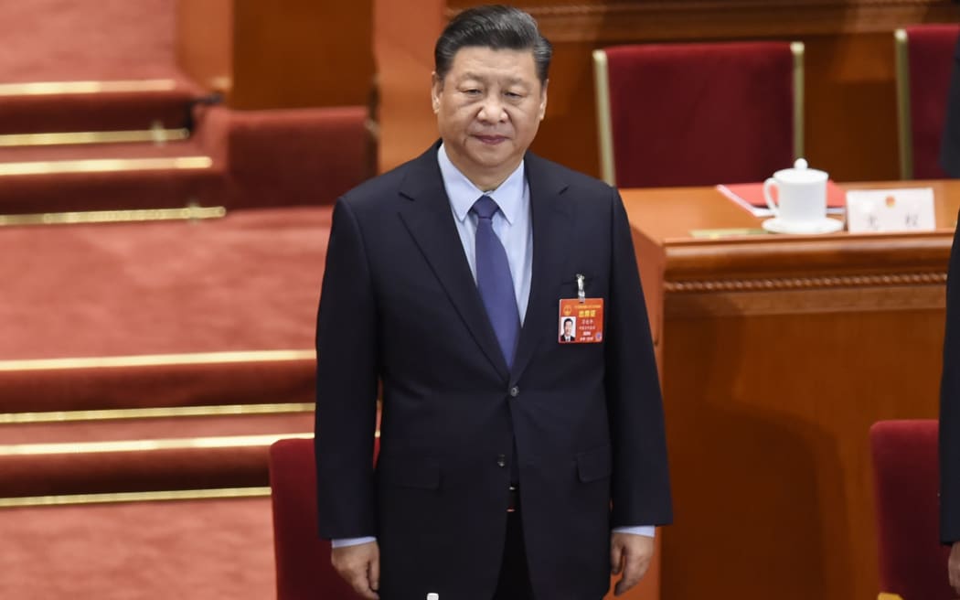 (FILES) This file photo taken on March 15, 2019 shows Chinese President Xi Jinping arriving for the closing session of the National People's Congress (NPC) in  Beijing's Great Hall of the People. -