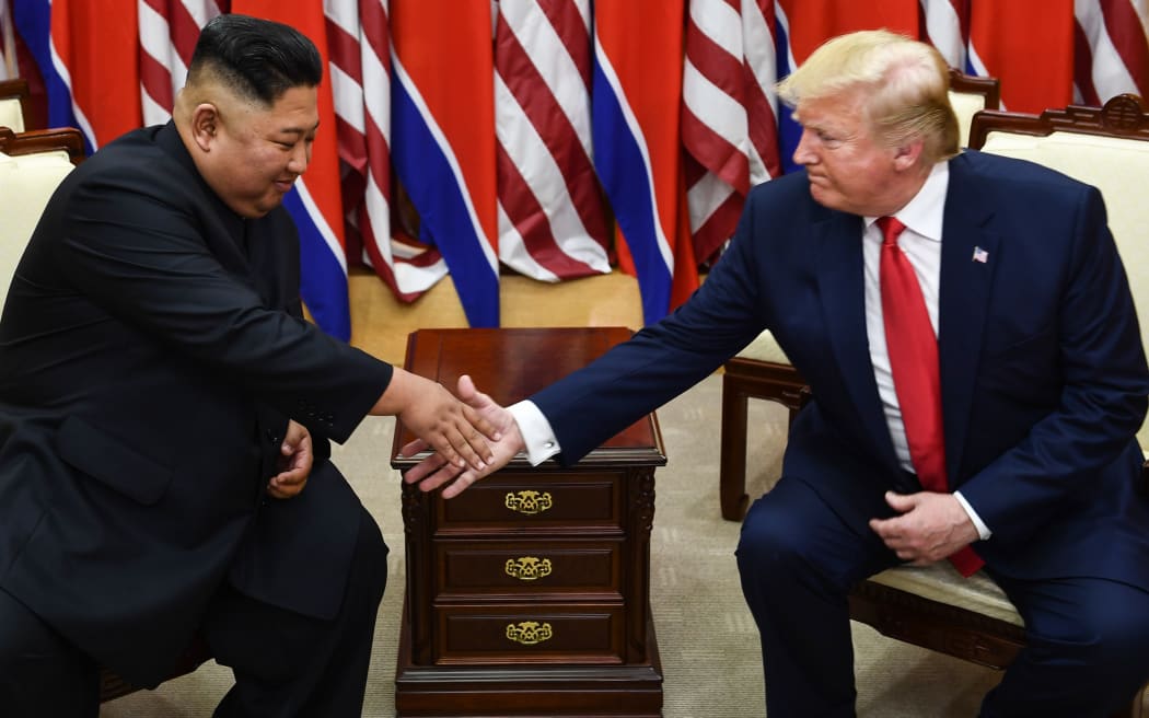 North Korea's leader Kim Jong Un (L) and US President Donald Trump shake hands during a meeting on the south side of the Military Demarcation Line that divides North and South Korea, in the Joint Security Area (JSA) of Panmunjom in the Demilitarized zone (DMZ) on June 30, 2019.