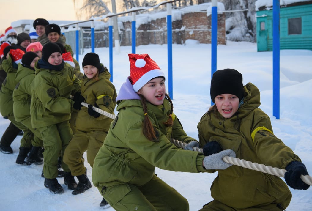 Students of specialised classes of the Russian National Guard pass through the winter "Assault strip" in the Kemerovo region, Russia.