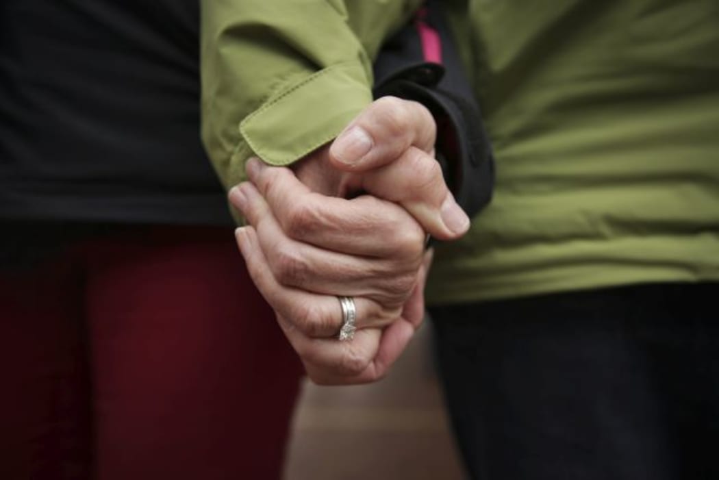 A close-up shot of a couple holding hands.