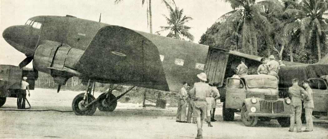Air Force trucks unloading supplies from a newly-arrived heavy transport plane in the South Pacific, 1943.