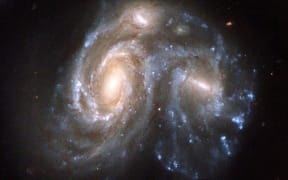 Picture released on April 24, 2008 by ESA shows the Arp 272, a collision between two spiral galaxies, NGC 6050 and IC 1179 part of the Hercules Galaxy Cluster and located in the constellation of Hercules, taken by the Hubble Space Telescope