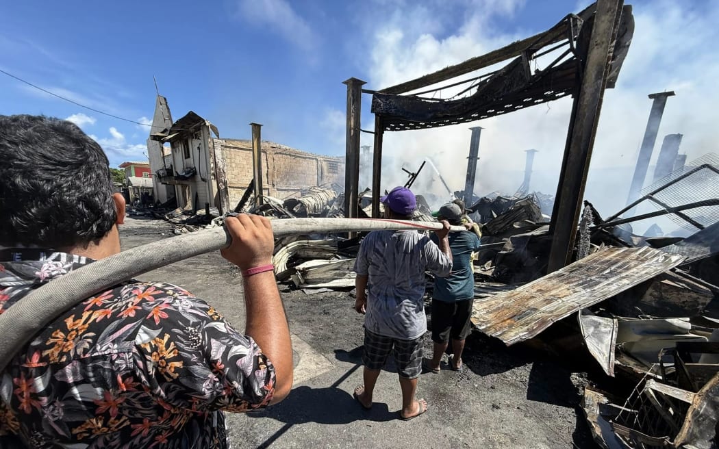 Ebeye residents helped firefighters on Ebeye Island to quell a blaze last Saturday that destroyed two major businesses and many homes, leaving at least 100 people homeless. Photo: Sherman Hogue, USAG-KA Public Affairs Officer.