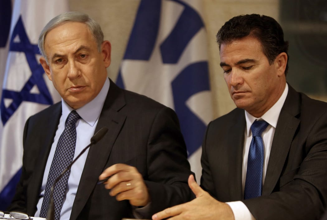 A file picture taken at the Israeli foreign ministry on October 15, 2015, shows Prime Minister Benjamin Netanyahu (L) sitting next to Yossi Cohen, who is currently the head of Israel's National Security Council, and who was named as the 12th head of the Mossad intelligence agency