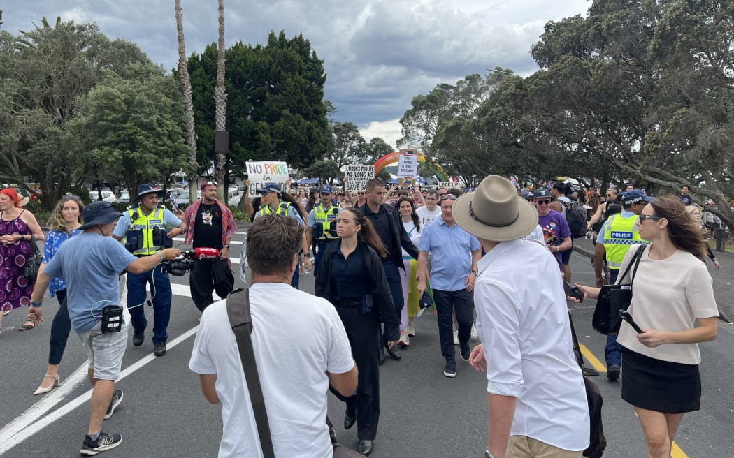 Protesters gather around Christopher Luxon and Nicola Willis at the Big Gay Out.