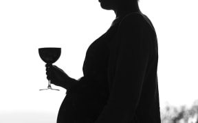 Generic pregnant woman drinking alcohol.