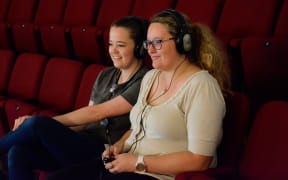 The APO's Katie Deller and Rowan Newton test out the new device to help those with hearing sensitivity at concerts