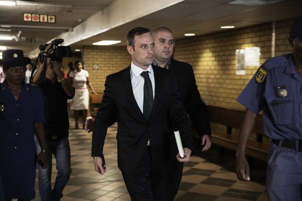 Former Paralympic champion Oscar Pistorius, centre, arrives at the South African Gauteng Division High Court in Pretoria on 8 December.
