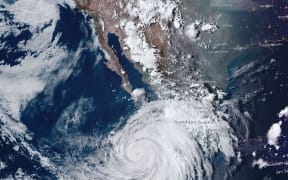 This handout satellite image courtesy of NOAA taken on August 16, 2023, shows hurricane Hilary approaching Baja California, Mexico. Tropical Storm Hilary strengthened into a major hurricane in the Pacific on August 16, 2023 and was expected to further intensify before approaching Mexico's Baja California peninsula over the weekend, forecasters said. Heavy rainfall was also expected in the southwestern United States from Friday as the storm moves north, the US National Hurricane Center (NHC) said. (Photo by NOAA / AFP) / RESTRICTED TO EDITORIAL USE - MANDATORY CREDIT "AFP PHOTO / NOAA" - NO MARKETING NO ADVERTISING CAMPAIGNS - DISTRIBUTED AS A SERVICE TO CLIENTS