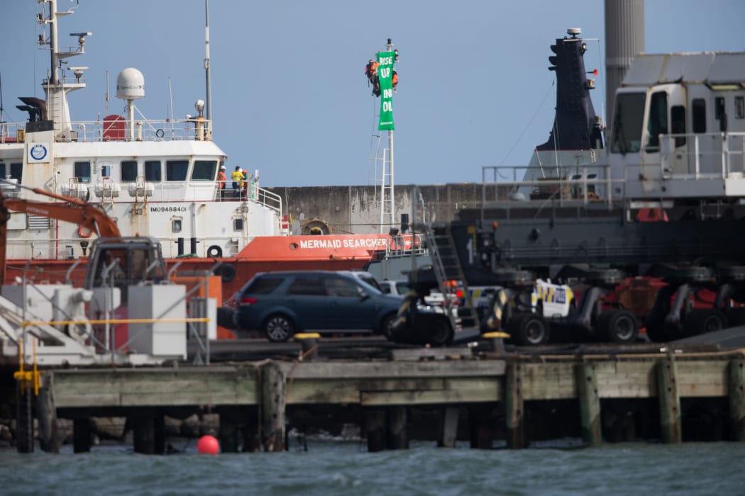 Greenpeace protesters chained to a pole on the tender vessel Mermaid Searcher.