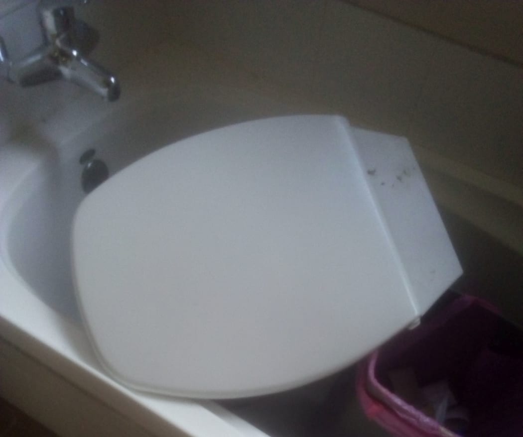 The toilet was disconnected and part of it was in the bath when the family returned.