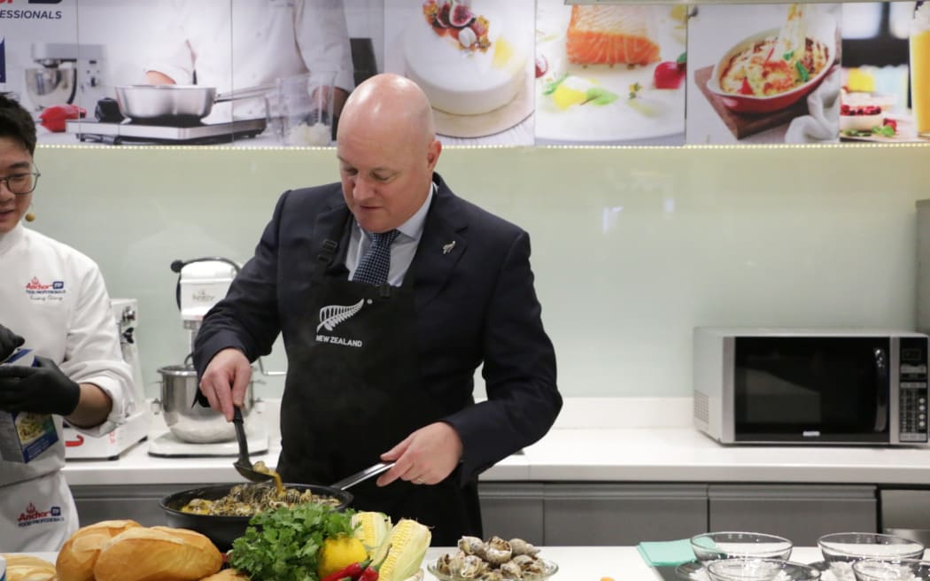 Christopher Luxon participates in a cooking demonstration at Fonterra's headquarters in Ho Chi Minh City.
