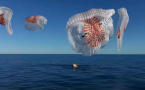 Parachutes are deployed as the pod carrying NASA astronauts Suni Williams and Butch Wilmore splashes down.