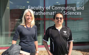 Karin and Nick stand in front of the Faculty of Computing and Mathematical Sciences.