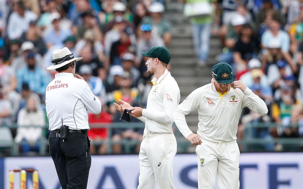 Australian fielder Cameron Bancroft is questioned by the umpires during the third day of the third Test cricket match between South Africa and Australia.